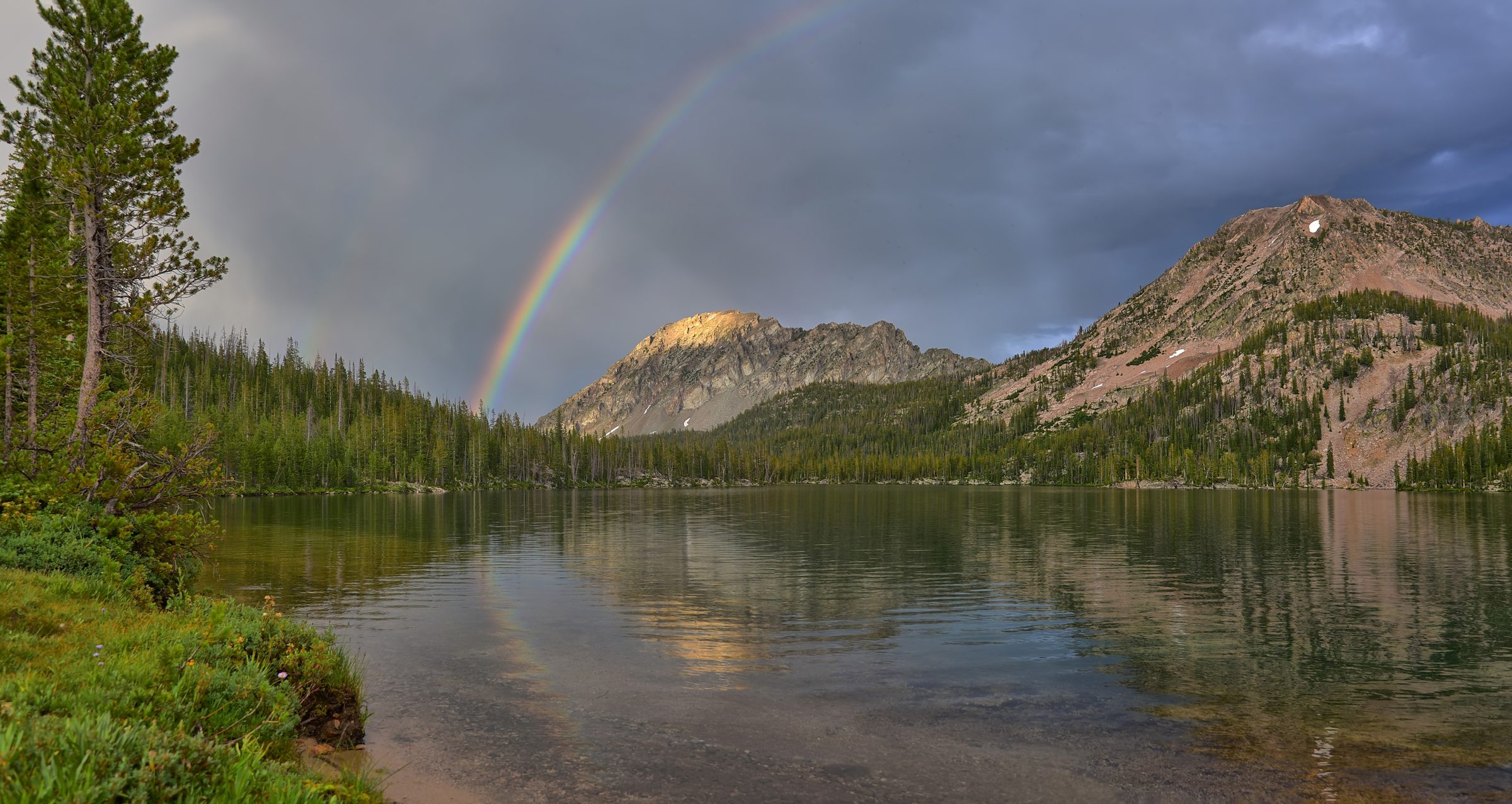 The Promised Sign — A rainbow spilling straight into a quiet lake.
